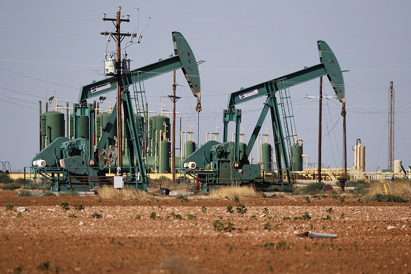 FILE - In this Wednesday, July 29, 2020 file photo, a view of a pump jack operateing in an oil field in Midland, Texas. A U.N.-backed study has found that the world needs to cut by more than half its production of coal, oil and gas in the coming decade to maintain a chance of keeping global warming from reaching dangerous levels. The report published Wednesday, Oct. 20, 2021 by the U.N. Environment Program noted that many governments have made ambitious pledges to curb greenhouse gas emissions. But it found they are still planning to extract double the amount of fossil fuels in 2030than what would be consistent withthe goal of keeping global temperature rise below 1.5 degrees Celsius (2.7 degrees Fahrenheit). AP Photo/Tony Gutierrez, File)(