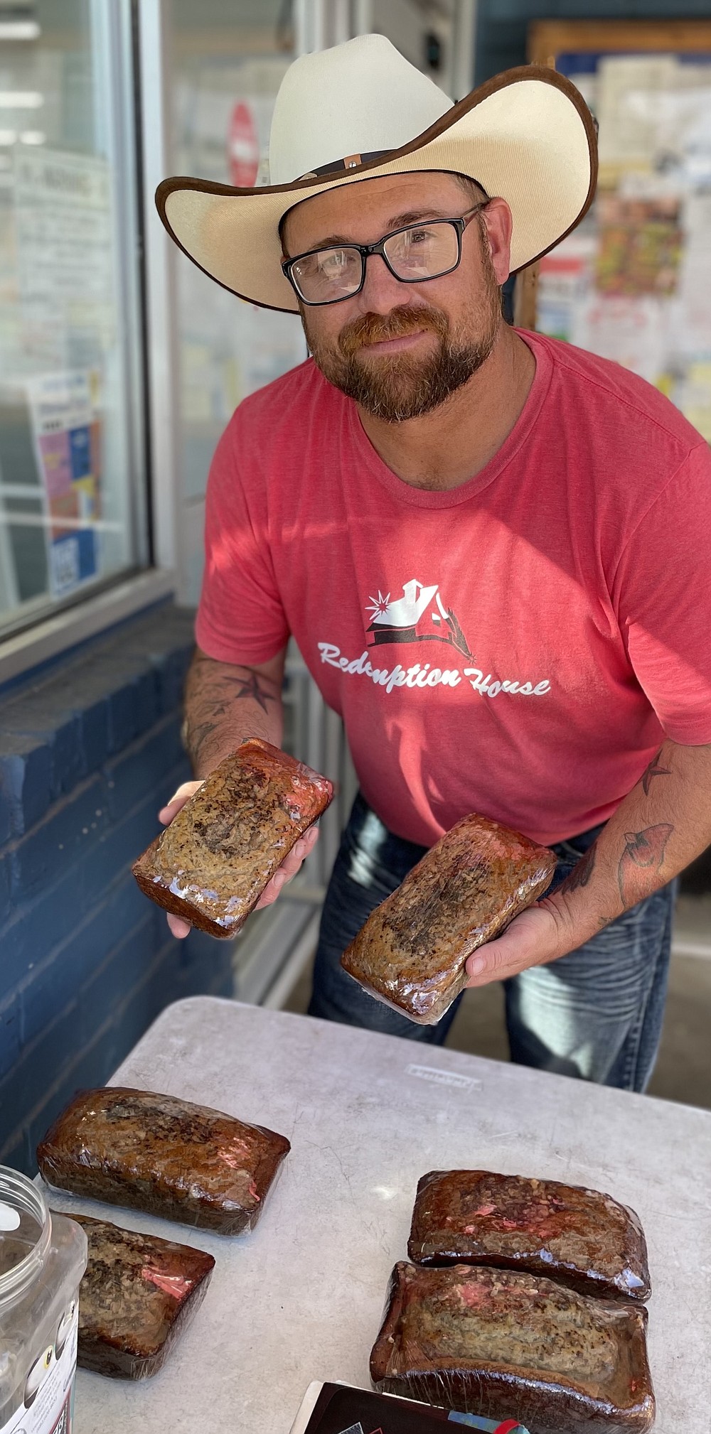 Justin Shane Cook of West Monroe, Louisiana, is selling banana nut bread while supporting Redemption House with Cindy Bishop Ministries in Winnsboro, Louisiana. From his table at Crump Food Center in Linden, he is also telling his story of recovering from addiction.
