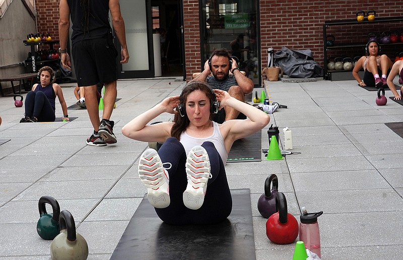 A rooftop exercise class in Manhattan, June 3, 2021. For the past five years or so, high-intensity interval training, or HIIT &#x460;brief spurts of intense exercise interspersed with rest &#x460;has been one of the most popular forms of exercise. But plenty of questions remain. (The New York Times/Michelle V. Agins)