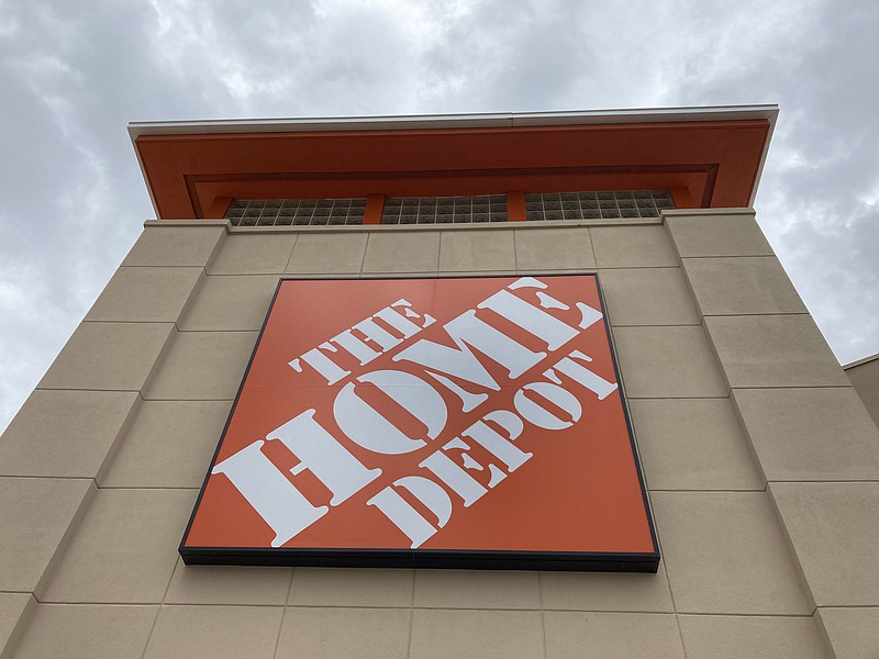 FILE - A Home Depot logo sign hangs on its facade, Friday, May 14, 2021, in North Miami, Fla. Home Depot’s sales were still climbing in the third quarter of 2021, as demand for its home improvements products continues. Revenue rose 9.8% to $36.82 billion. (AP Photo/Wilfredo Lee, File)