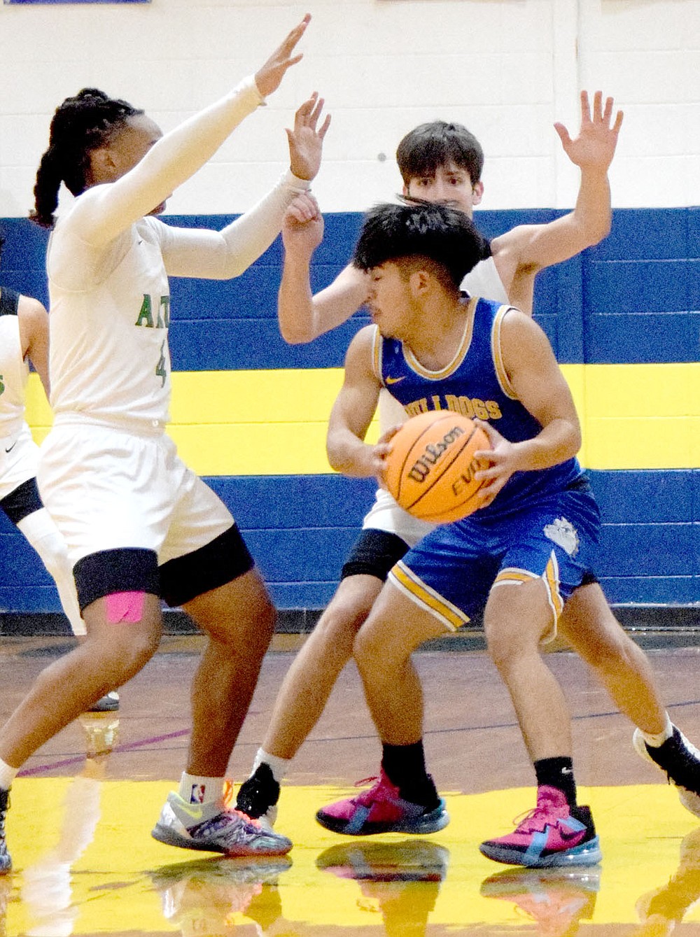 Westside Eagle Observer/MIKE ECKELS
Christian Ramirez (right) finds his path blocked by a pair of Diamond players during the first quarter of the Decatur-Arts Academy basketball contest at Peterson Gym in Decatur Thursday night. Ramirez just put his head down and drove the ball between the two players and on to the basket for a two point layup.