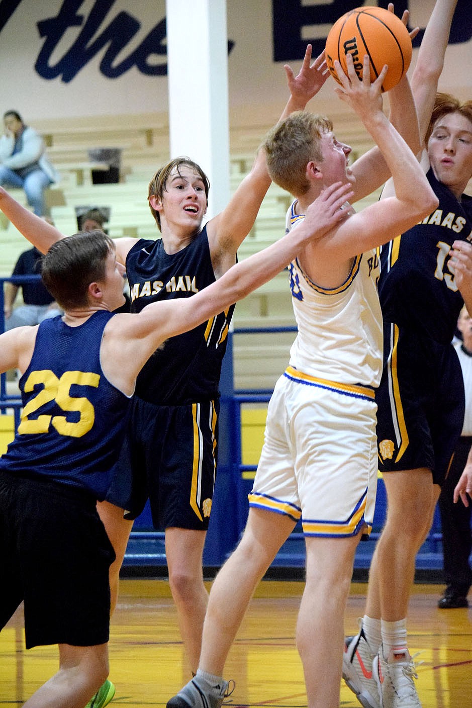 Westside Eagle Observer/MIKE ECKELS
In the middle of a pack of Mastiff players, lone Bulldog Deegan Brooks manages to put up a jumper that hit its mark during the third quarter of the Decatur-Haas Hall-Fayetteville basketball contest in Decatur Nov. 15. The Bulldogs, playing in the Decatur Invitational Basketball Tournament, defeated the Mastiffs 56-35 to advance to the winners round.