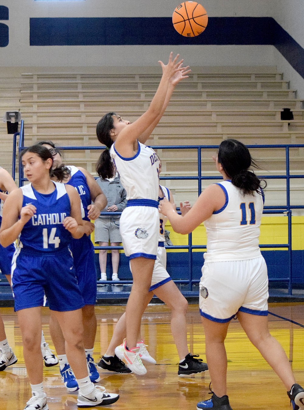 Westside Eagle Observer/MIKE ECKELS
Jasmine Herrera (center) reaches high to capture a rebound during the second quarter of the Decatur-Ozark Catholic basketball game at Peterson Gym in Decatur Saturday afternoon.