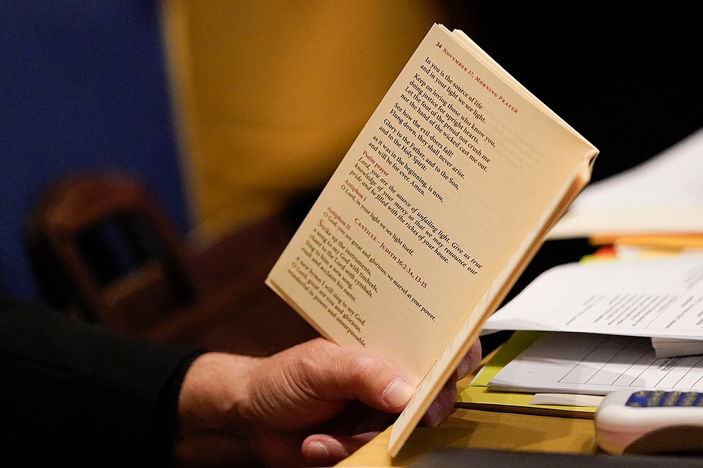 Bishop Manuel Cruz, of the Roman Catholic Archdiocese of Newark, N.J., reads scripture during a morning prayer at the Fall General Assembly meeting of the United States Conference of Catholic Bishops, Wednesday, Nov. 17, 2021, in Baltimore.(AP Photo/Julio Cortez)
