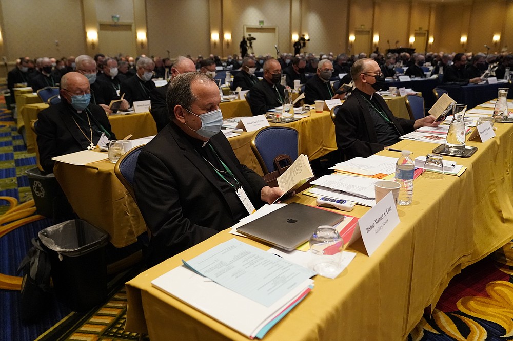 Bishop Manuel Cruz, front left, of the Roman Catholic Archdiocese of Newark, N.J., reads scripture during a morning prayer at the Fall General Assembly meeting of the United States Conference of Catholic Bishops, Wednesday, Nov. 17, 2021, in Baltimore.(AP Photo/Julio Cortez)