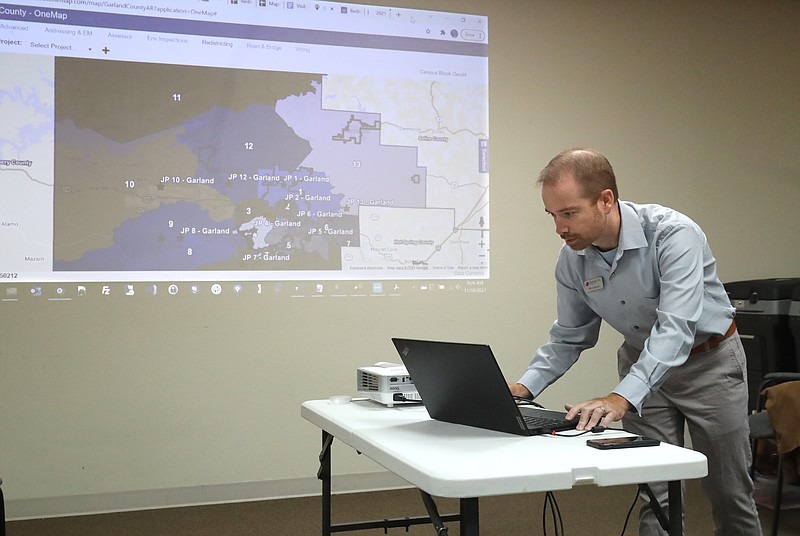 DataScout LLC Director of Geospatial Services Matthew Charton presents the 2020 justice of the peace draft map to the Garland County Election Commission Thursday at the election commission building. - Photo by Richard Rasmussen of The Sentinel-Record