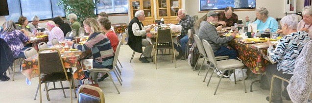 Westside Eagle Observer/SUSAN HOLLAND
Patrons and guests at Billy V. Hall Senior Activity Center enjoy Thanksgiving dinner at the Center Thursday, Nov. 18. Several came out to eat lunch and participate in activities which included a watercolor class and drawings for a quilt raffle and secret Santa participants. Ilona Anderson, LaVonda Augustine and Penny Leonard were winners of quilts.