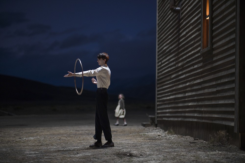 This image released by Netflix shows Kodi Smit-McPhee in a scene from "The Power of the Dog" (Kirsty Griffin/Netflix via AP)