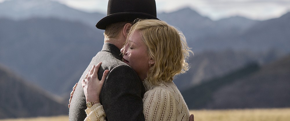 This image released by Netflix shows Jesse Plemons, left, and Kirsten Dunst in a scene from "The Power of the Dog" (Netflix via AP)