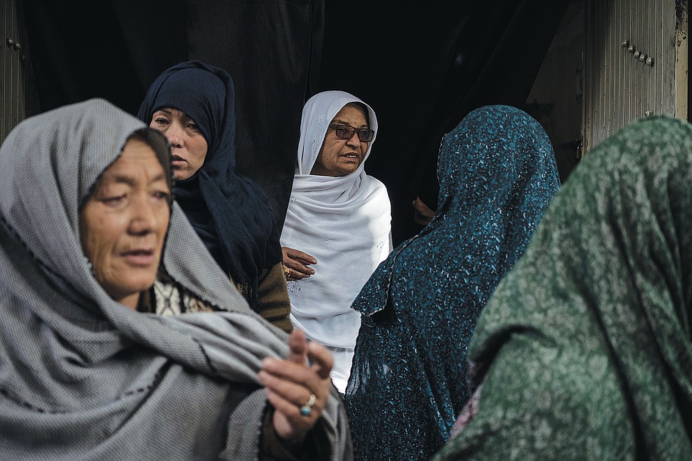 Women leave a Shiite shrine in a predominantly Hazara neighborhood in Kabul, Afghanistan, Tuesday, Nov. 9, 2021. A strange, new relationship is developing in Afghanistan following the takeover by the Taliban three months ago. The Taliban, Sunni hard-liners who for decades targeted the Hazaras as heretics, are now their only protection against a more brutal enemy: the Islamic State group. (AP Photo/Bram Janssen)