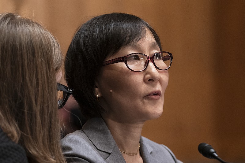 Saule Omarova of New York confers with an aide as she testifies before a Senate Banking, Housing, and Urban Affairs hearing on Capitol Hill in Washington to examine her nomination to be the Comptroller of the Currency, Thursday, Nov. 18, 2021. (AP Photo/Manuel Balce Ceneta)