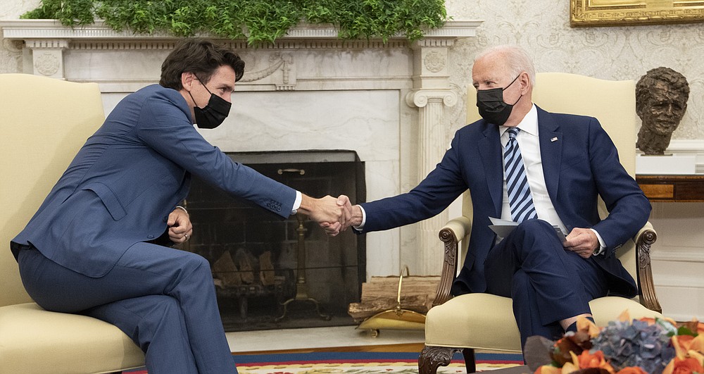 President Joe Biden shakes hands with Canadian Prime Minister Justin Trudeau as they meet in the Oval Office of the White House, Thursday, Nov. 18, 2021, in Washington. ( Adrian Wyld/The Canadian Press via AP)