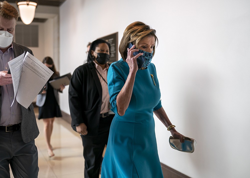Speaker of the House Nancy Pelosi, D-Calif., walks to meet with reporters about plans to pass President Joe Biden's domestic agenda as the House meets to debate the "Build Back Better" Act, at the Capitol in Washington, Thursday, Nov. 18, 2021. (AP Photo/J. Scott Applewhite)