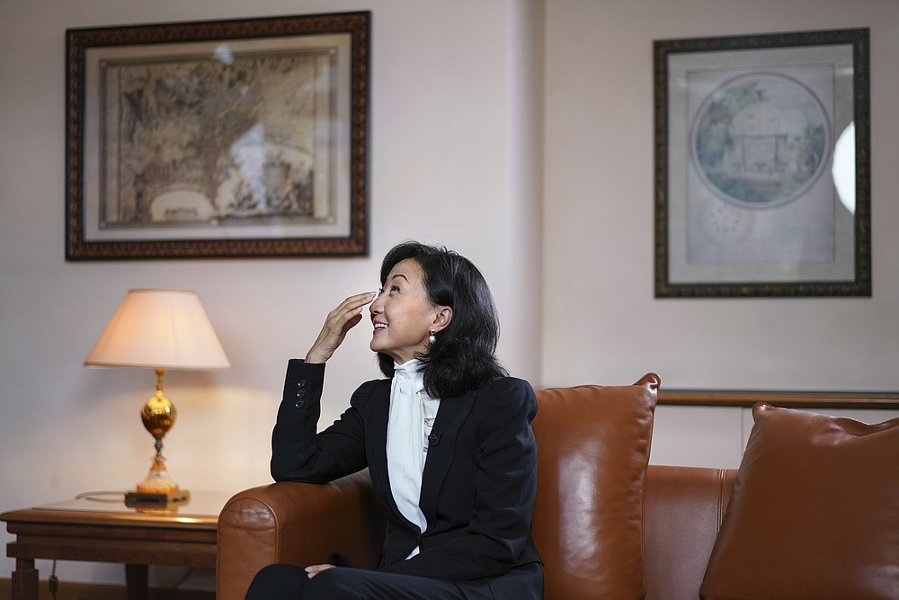 Grace Meng, the wife of former Interpol president Meng Hongwei, reacts as she answers the Associated Press in Lyon, central France, Tuesday, Nov.16, 2021. In the exclusive interview, Meng chose to show her face for the first time since her husband disappeared in China in 2018, agreeing to be filmed and photographed without the dark lighting and from-the-back camera angles that she had previously insisted on. She did so to be able to speak openly and in unprecedented detail about her husband's imprisonment, herself and the cataclysm that tore them apart. (AP Photo/Laurent Cipriani)