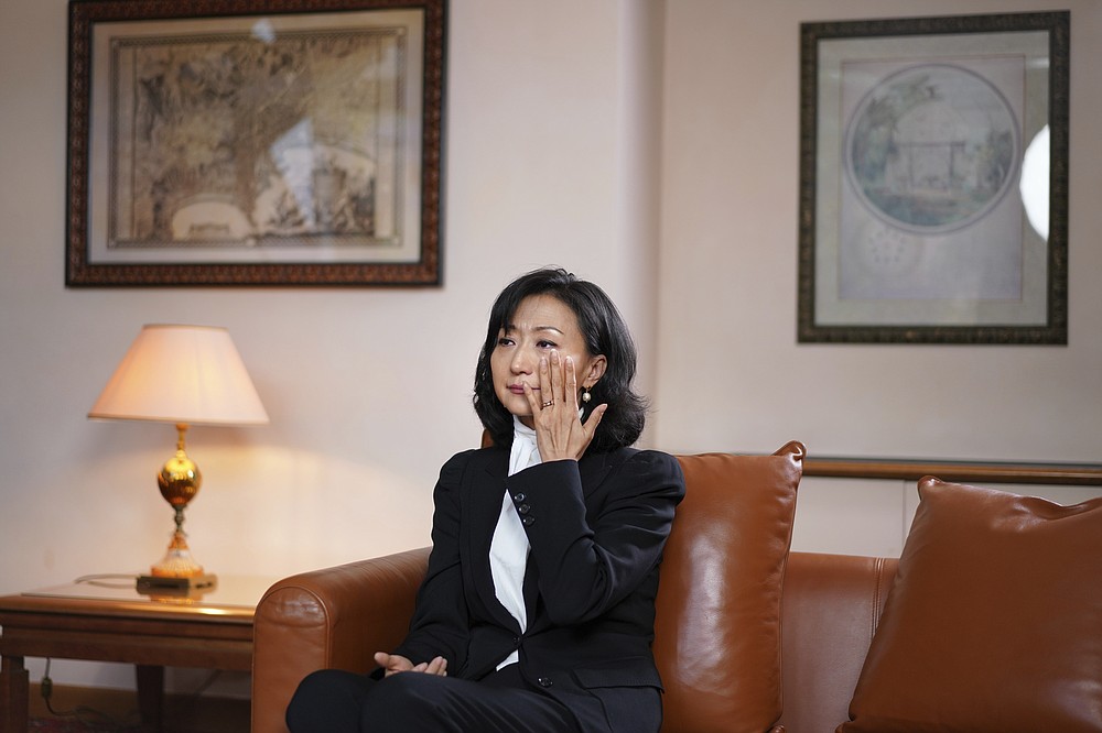 Grace Meng, the wife of former Interpol president Meng Hongwei, answers the Associated Press in Lyon, central France, Tuesday, Nov.16, 2021. Meng Hongwei has now disappeared into China's sprawling penal system, purged in a stunning fall from grace. And his wife is alone with their twin boys in France, a political refugee under round-the-clock police protection following a suspected plot by Chinese agents to kidnap and deliver them to an uncertain fate. (AP Photo/Laurent Cipriani)