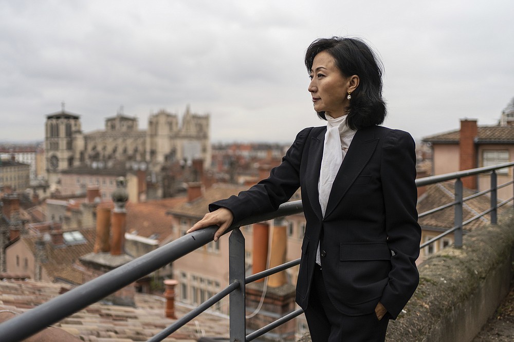 Grace Meng, the wife of former Interpol president Meng Hongwei, poses for a photo after an interview with the Associated Press in Lyon, central France, Tuesday, Nov. 16, 2021. (AP Photo/Laurent Cipriani)