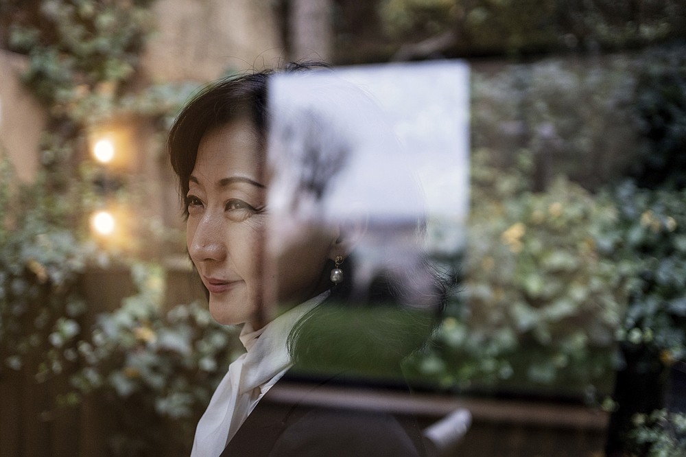 Grace Meng, the wife of former Interpol president Meng Hongwei, poses after an interview with the Associated Press in Lyon, central France, Tuesday, Nov.16, 2021. Meng Hongwei has now disappeared into China's sprawling penal system, purged in a stunning fall from grace. And his wife is alone with their twin boys in France, a political refugee under round-the-clock police protection following a suspected plot by Chinese agents to kidnap and deliver them to an uncertain fate. (AP Photo/Laurent Cipriani)