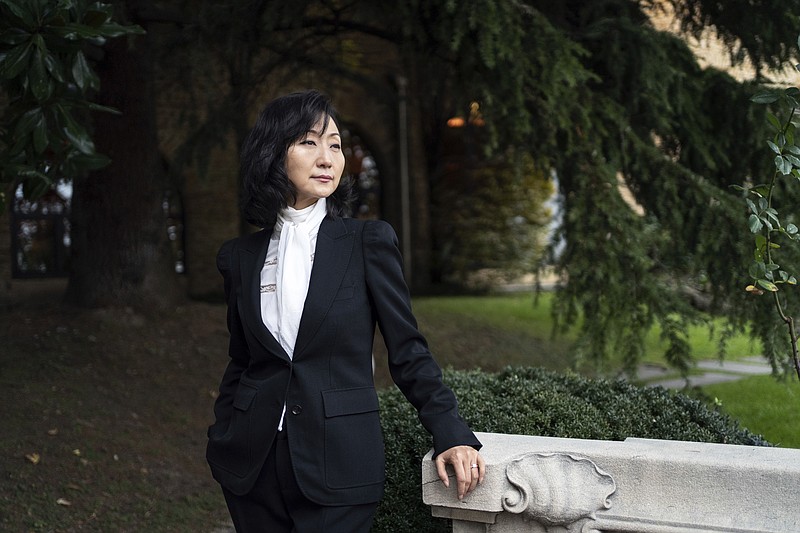 Grace Meng, the wife of former Interpol president Meng Hongwei, poses for a photo after an interview with the Associated Press in Lyon, central France, Tuesday, Nov. 16, 2021. In the exclusive interview, Meng chose to show her face for the first time since her husband disappeared in China in 2018, agreeing to be filmed and photographed without the dark lighting and from-the-back camera angles that she had previously insisted on. She did so to be able to speak openly and in unprecedented detail about her husband's imprisonment, herself and the cataclysm that tore them apart. (AP Photo/Laurent Cipriani)
