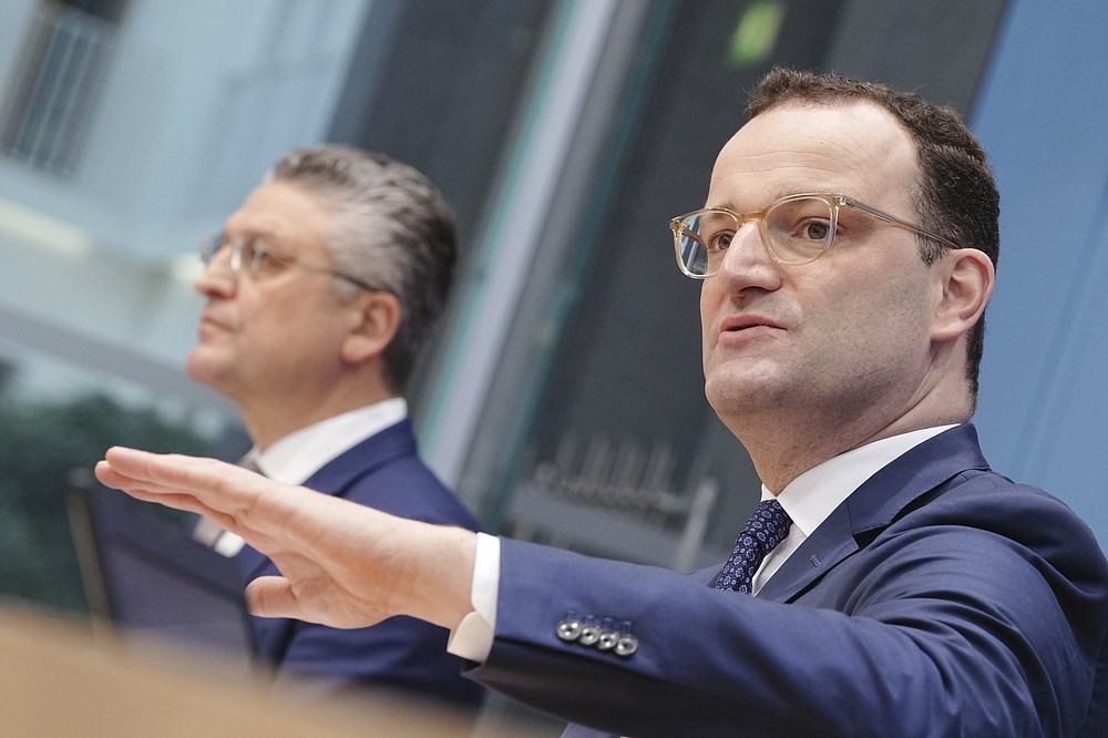 Jens Spahn, right, Executive Federal Minister of Health, and Lothar H. Wieler, President of the Robert Koch Institute (RKI), give a press conference on the Corona pandemic in Berlin, Germany, Friday, Nov.19, 2021. (Kay Nietfeld/dpa via AP)