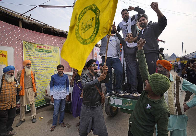 Farmers shout slogans as they celebrate news of the repeal of farm laws they were protesting against, in Singhu, on the outskirts of New Delhi, India, Friday, Nov. 19, 2021. In a surprise announcement, India's Prime Minister Narendra Modi said Friday his government will withdraw the controversial agriculture laws that prompted yearlong protests from tens of thousands of farmers and posed a significant political challenge to his administration. (AP Photo/Manish Swarup)