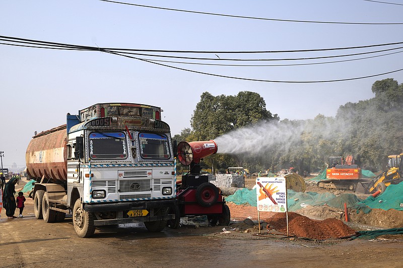 An anti-smog gun is used to control dust at a construction side in New Delhi, India, Thursday, Nov. 18, 2021. Air pollution remained extremely high in the Indian capital on Thursday, a day after authorities closed schools indefinitely and shut some power stations to reduce smog that has blanketed the city for much of the month. (AP Photo/Manish Swarup)