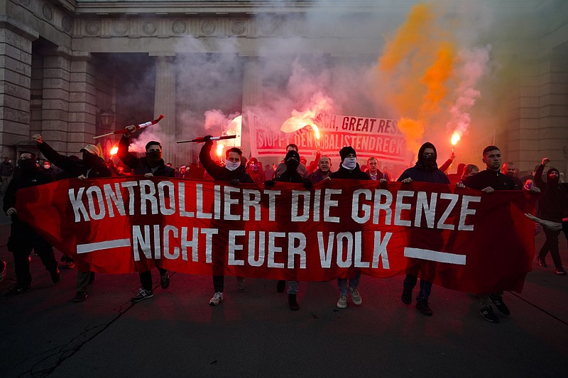 The Associated Press
Demonstrators shout slogans and light flares during a demonstration against measures to battle the coronavirus pandemic in Vienna, Austria, on Saturday. Thousands of protesters are expected to gather in Vienna after the Austrian government announced a nationwide lockdown to contain the quickly rising coronavirus infections in the country. The banner reads: "Controls the border. Not your people."