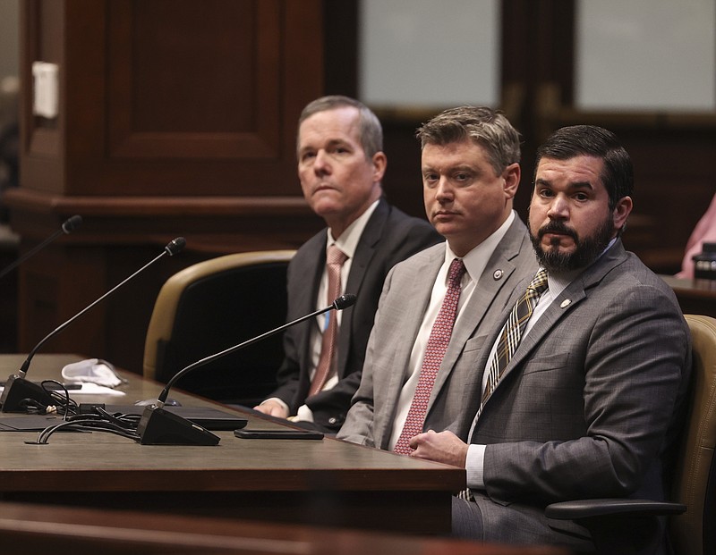 Dr. Cam Patterson, left, UAMS Chancellor, Brian Bowen, middle, Chief of Staff for the Attorney General, and Bradford Nye, Legislative Director for the Attorney General, answer questions Friday Nov. 19, during a meeting of the Arkansas Legislative Council at the state Capitol. (Arkansas Democrat-Gazette/Staton Breidenthal)