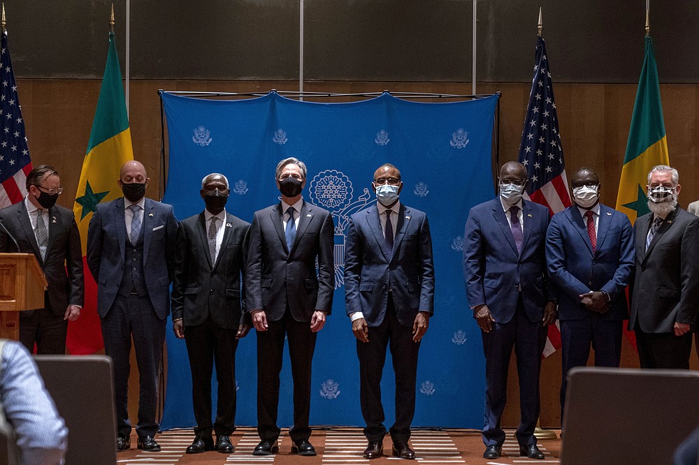 US Secretary of State Antony Blinken, center and Senegal's Minister of Economy, Planning and International Cooperation Amadou Hott, center right, pose for photographs at signing ceremony between American backed companies with Senegal at the Radisson Blu Hotel in Dakar, Nigeria, Saturday, Nov. 20, 2021. Blinken is on a five day trip to Kenya, Nigeria, and Senegal. (AP Photo/Andrew Harnik, Pool)