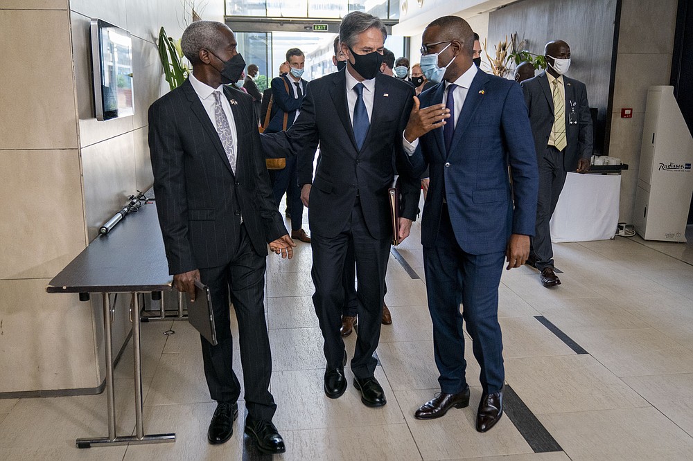 From left, U.S. Ambassador to Senegal Tulinabo Mushingi, US Secretary of State Antony Blinken and Senegal's Minister of Economy, Planning and International Cooperation Amadou Hott arrive for a commercial diplomacy event with U.S. companies and the government of Senegal at the Radisson Blu Hotel in Dakar, Nigeria, Saturday, Nov. 20, 2021. Blinken is on a five day trip to Kenya, Nigeria, and Senegal. (AP Photo/Andrew Harnik, Pool)