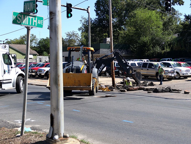 Employees for Centerpoint Energy work to repair a gas line at Main Street and Smith Avenue in this News-Times file photo. Centerpoint has sold its local natural gas distribution assets to Summit Utilities, Inc, and the El Dorado City Council assigned the new company franchise rights last week.