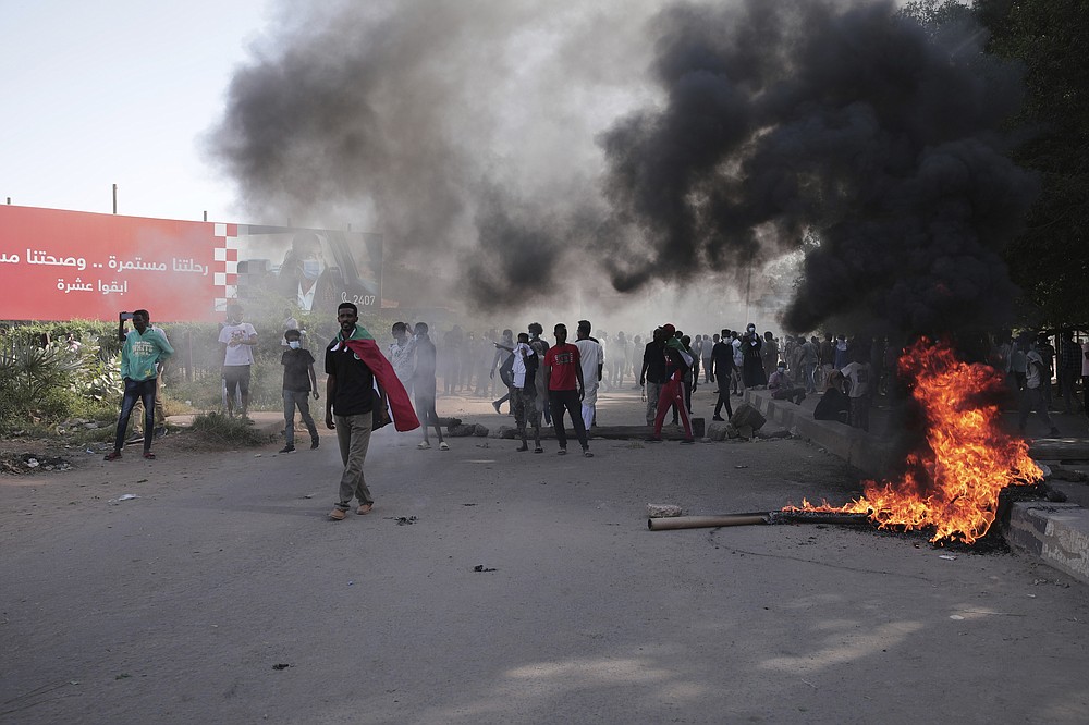 Sudanese protest against the military takeover, which upended the country’s fragile transition to democracy, in Khartoum, Sudan, Sunday, Nov. 21, 2021. Sudan’s military and civilian leaders signed a deal Sunday to reinstate Prime Minister Abdalla Hamdok, who was deposed in a coup last month. The country’s top general, Abdel Fattah Burhan, said in televised statements that Hamdok will lead an independent technocratic Cabinet until elections can be held. (AP Photo/Marwan Ali)