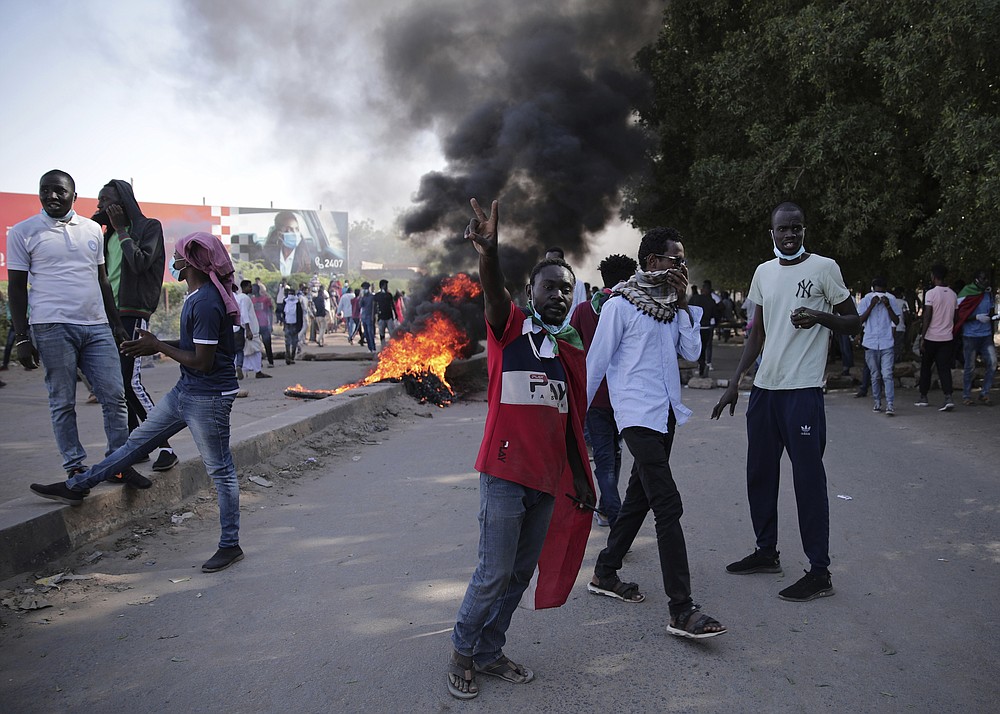Sudanese protest against the military takeover, which upended the country’s fragile transition to democracy, in Khartoum, Sudan, Sunday, Nov. 21, 2021. Sudan’s military and civilian leaders signed a deal Sunday to reinstate Prime Minister Abdalla Hamdok, who was deposed in a coup last month. The country’s top general, Abdel Fattah Burhan, said in televised statements that Hamdok will lead an independent technocratic Cabinet until elections can be held. (AP Photo/Marwan Ali)