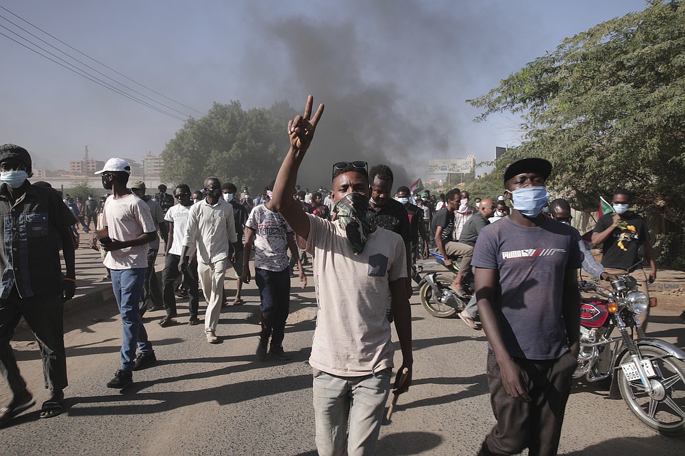 Sudanese protest against the military takeover, which upended the country’s fragile transition to democracy, in Khartoum, Sudan, Sunday, Nov. 21, 2021. Sudan’s military and civilian leaders signed a deal Sunday to reinstate Prime Minister Abdalla Hamdok, who was deposed in a coup last month. The country’s top general, Abdel Fattah Burhan, said in televised statements that Hamdok will lead an independent technocratic Cabinet until elections can be held. (AP Photo/Marwan Ali)