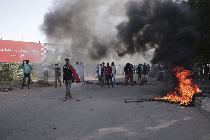 Sudanese protest against the military takeover, which upended the country?s fragile transition to democracy, in Khartoum, Sudan, Sunday, Nov. 21, 2021. Sudan?s military and civilian leaders signed a deal Sunday to reinstate Prime Minister Abdalla Hamdok, who was deposed in a coup last month. The country?s top general, Abdel Fattah Burhan, said in televised statements that Hamdok will lead an independent technocratic Cabinet until elections can be held. (AP Photo/Marwan Ali)