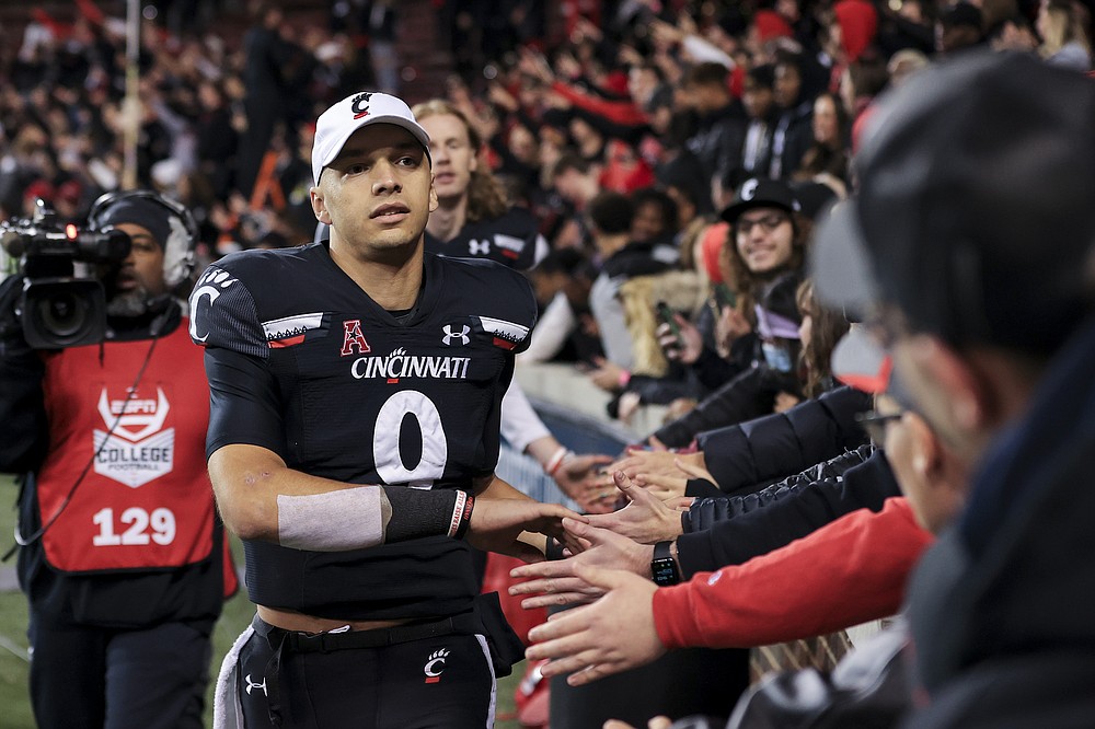 Cincinnati quarterback Desmond Ridder celebrates with fans after the team's NCAA college football game against SMU, Saturday, Nov. 20, 2021, in Cincinnati. (AP Photo/Aaron Doster)