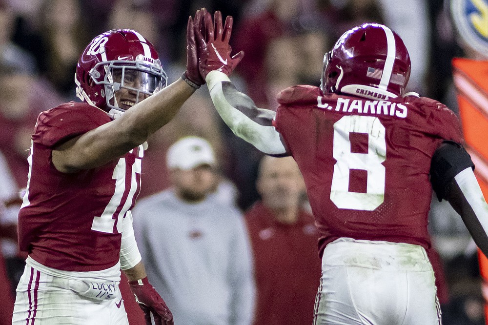 Alabama linebackers Henry To'oTo'o (10) and Christian Harris (8) high-five after a stop of Arkansas during the second half of an NCAA college football game Saturday, Nov. 20, 2021, in Tuscaloosa, Ala. (AP Photo/Vasha Hunt)