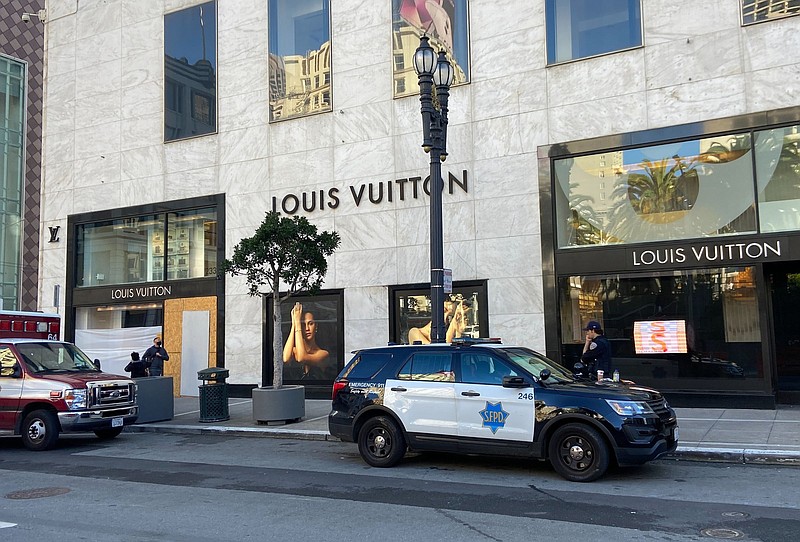 Police officers and emergency crews park outside the Louis Vuitton store in San Francisco's Union Square on Sunday, Nov. 21, 2021, after looters ransacked businesses late Saturday night. (Danielle Echeverria/San Francisco Chronicle via AP)