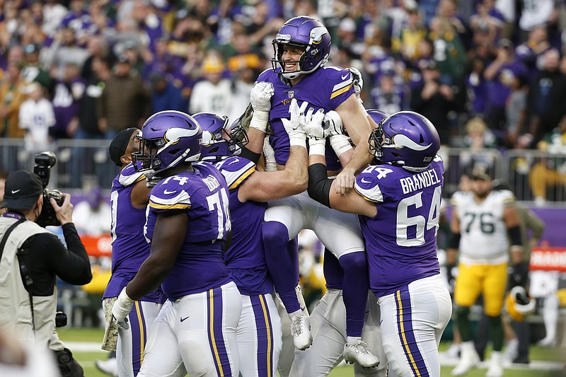 Minnesota Vikings kicker Greg Joseph, center, celebrates with teammates after kicking a 29-yard field goal on the final play of an NFL football game against the Green Bay Packers, Sunday, Nov. 21, 2021, in Minneapolis. The Vikings won 34-31. (AP Photo/Bruce Kluckhohn)