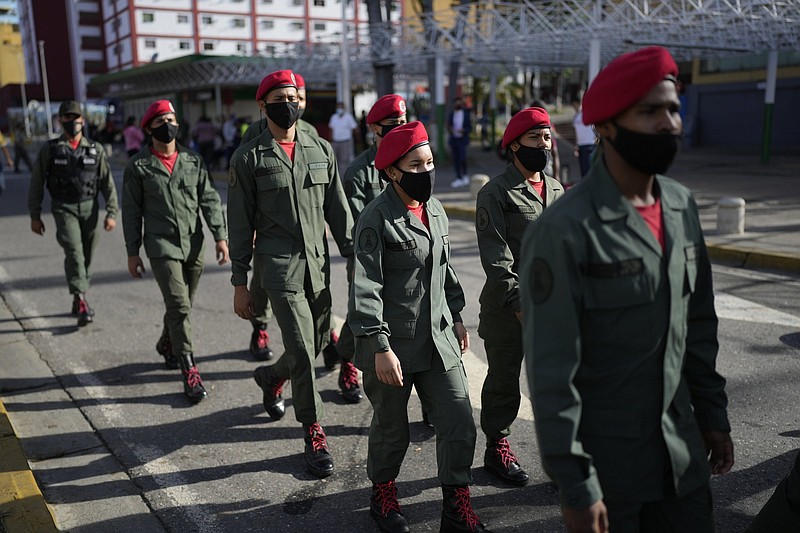 Soldiers arrive to vote during regional elections, at a polling station in the Fermin Toro school in Caracas, Venezuela, Sunday, Nov. 21, 2021. Venezuelans go to the polls to elect state governors and other local officials. (AP Photo/Ariana Cubillos)