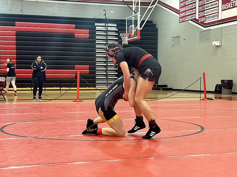 ALEXUS UNDERWOOD/SPECIAL TO MCDONALD COUNTY PRESS The MCHS Girls Wrestling Team competed at a home tournament held Nov. 19, at MCHS. Teryn Torrez prepares to sprawl as her opponent, A. Gosvener from Cassville, takes a two-point shot. Gosvener wins the match by pinning Torrez.