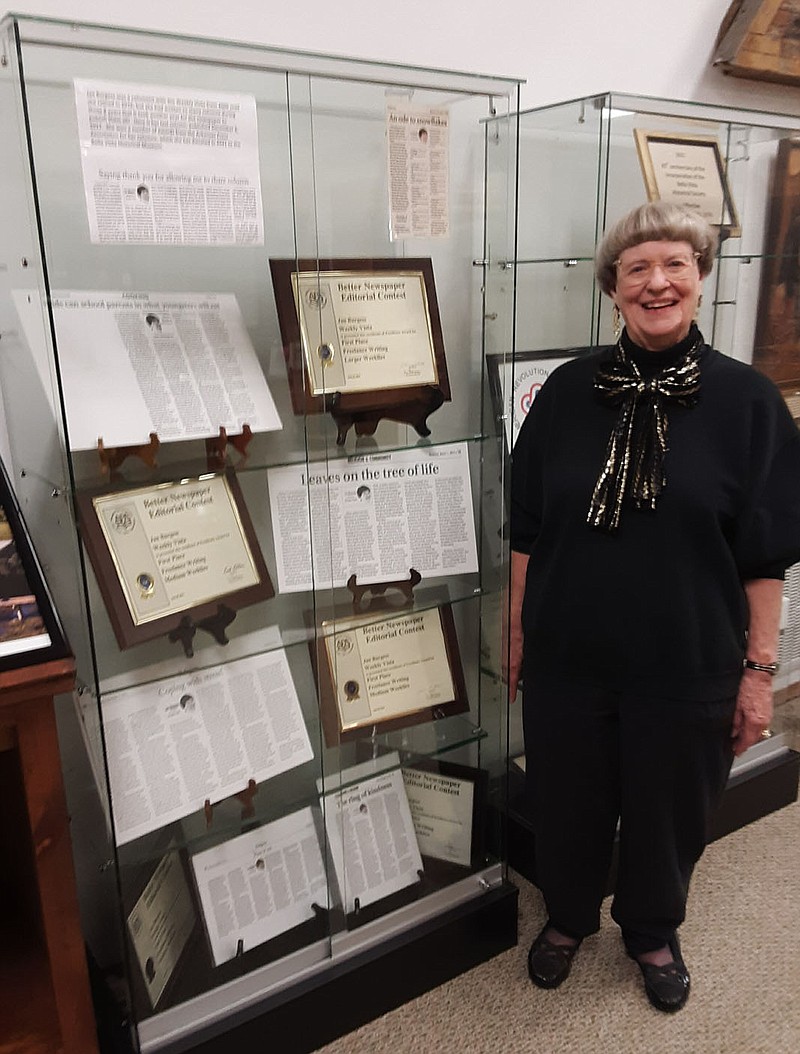 Photo courtesy Xyta Lucas Jan Burgess, former columnist with The Weekly Vista, stands with some of her award winning columns featured in a new exhibit at the Bella Vista historical Museum.