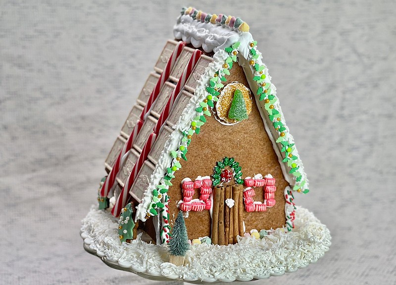 This completed Gingerbread House is decorated with meltaway mints, gummy canides, peppermints, peppermint bark, sprinkles, sparkling sugar and nonpareils. Shredded coconut provides a bed of snow. (Arkansas Democrat-Gazette/Kelly Brant)