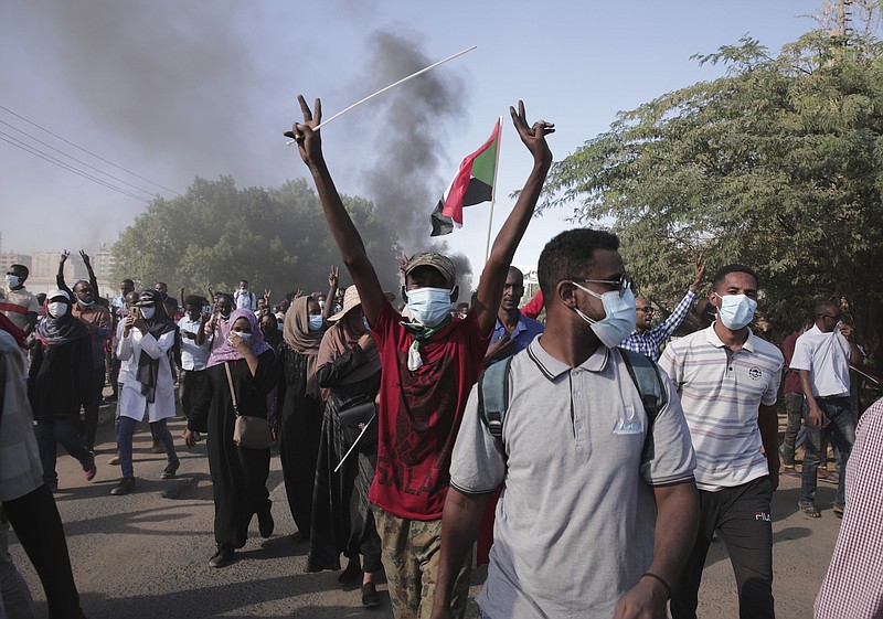 Sudanese protest against the military takeover, which upended the country&#x2019;s fragile transition to democracy, in Khartoum, Sudan, Sunday, Nov. 21, 2021. Sudan&#x2019;s military and civilian leaders signed a deal Sunday to reinstate Prime Minister Abdalla Hamdok, who was deposed in a coup last month. The country&#x2019;s top general, Abdel Fattah Burhan, said in televised statements that Hamdok will lead an independent technocratic Cabinet until elections can be held. (AP Photo/Marwan Ali)