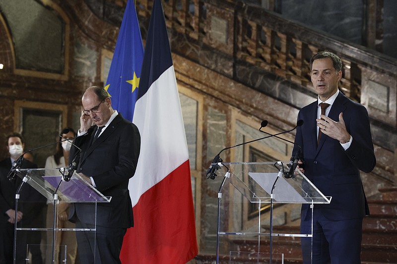 French Prime Minister Jean Castex, left, listens to the translation as Prime Minister Alexander De Croo of Belgium, right, gives a statement after a Belgian-French security consultation meeting at Egmont Palace in Brussels, Monday, Nov. 22, 2021. (AP Photo/Olivier Matthys)