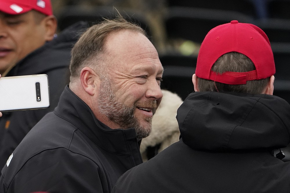 FILE - Alex Jones, left, attends a rally in support of President Donald Trump called the "Save America Rally," on Jan. 6, 2021, in Washington. The committee investigating the Jan. 6 Capitol insurrection has issued subpoenas to five more individuals, including Donald Trump's ally Roger Stone and conspiracy theorist Jones.(AP Photo/Jacquelyn Martin, File)