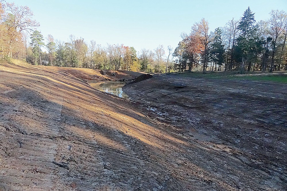 A pond is beginning, and water is starting to gather along the drainage project ditch in south Linden close to the Senior Citizens Center. Looking south one can see the earthen dam with its culvert and its spillway to come, the purpose of which is to regulate the flow especially of storm water.