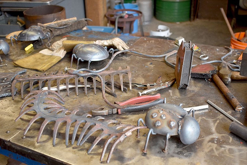 Rachel Dickerson/The Weekly Vista Works in progress are shown on Tom Flynn's work bench. A centipede made of two yard rakes and a ladybug are shown.