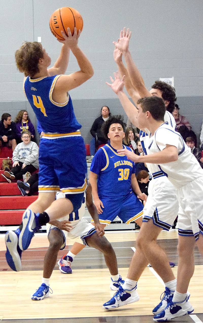 Westside Eagle Observer/MIKE ECKELS

Landon Watson (Bulldogs 4) goes up high for a jumper late in the fourth quarter of the Ozark Catholic-Decatur varsity basketball game at the Arkansas Athletes Outreach gym in Rogers Nov. 22. Watson missed his shot and the rebound went to the Griffins who hit a field goal at the other end of the court.