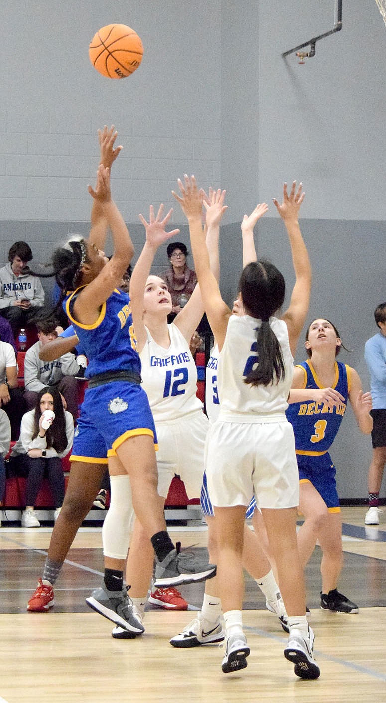 Westside Eagle Observer/MIKE ECKELS
Lady Bulldog Naomi Jimenez (left) goes up for a rebound during the Nov. 22 Ozark Catholic Academy-Decatur varsity girls basketball contest at the Arkansas Athletes Outreach gym in Rogers. The Lady Griffins took the win 51-24 over the Lady Bulldogs.