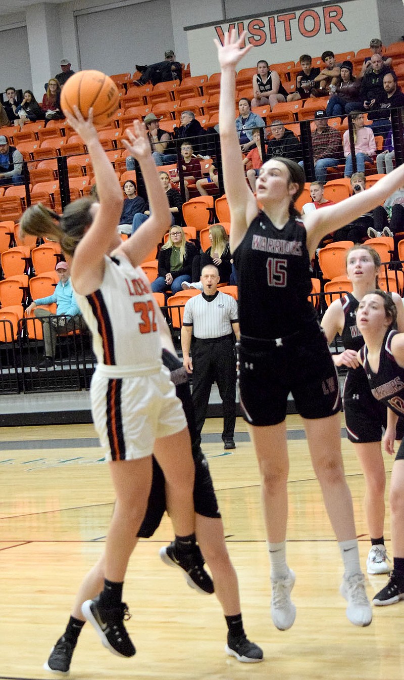 Westside Eagle Observer/MIKE ECKELS
Lady Lion Brooke Handle (32) puts up a one handed jumper from the middle of the lane during the Nov. 23 Gravette-Life Way Christian basketball contest at the Lions' Den in Gravette. The Lady Lions held on to defeat the Lady Warriors 38-36 in the nonconference contest.